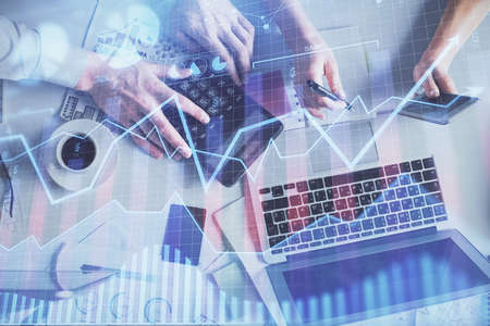 Double exposure of man and woman working together and financial chart hologram drawing. market...