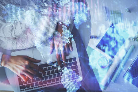 Multi exposure of woman hands working on computer and forex chart hologram drawing. Top View....