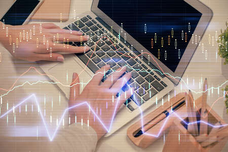 Multi exposure of woman hands typing on computer and forex chart hologram drawing. Stock market...