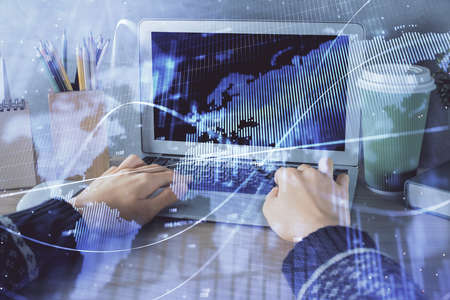 Double exposure of woman hands typing on computer and forex chart hologram drawing. Stock market...