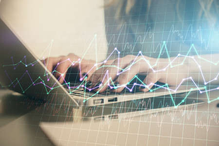 Double exposure of woman hands typing on computer and forex chart hologram drawing. Stock market invest concept.の写真素材