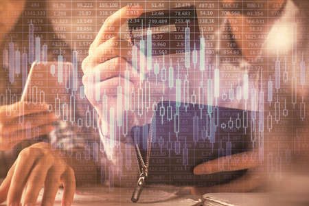 Double exposure of man and woman on-line shopping holding a credit card and forex graph hologram...