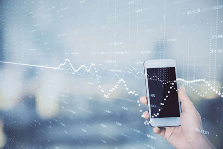 Double exposure of forex chart sketch hologram and woman holding and using a mobile device. Stock market concept.の写真素材