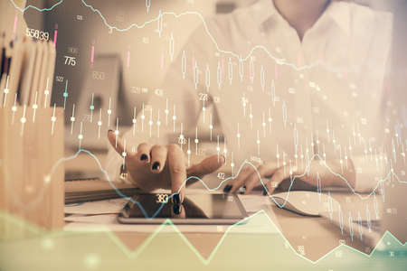 Double exposure of forex chart sketch hologram and woman holding and using a mobile device....
