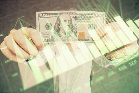 Multi exposure of forex graph drawing hologram and USA dollars bills and man hands. Technical Analysis concept.の写真素材