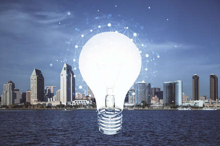 Multi exposure of bulb hologram drawing and cityscape background. Concept of idea.