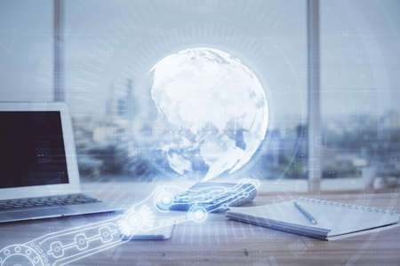 Double exposure of desktop with computer and world map hologram. International data network concept.の写真素材