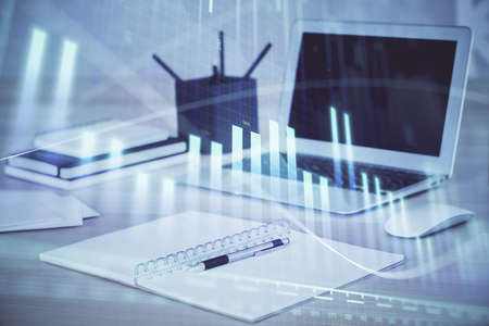 Forex Chart hologram on table with computer background. Multi exposure. Concept of financial...