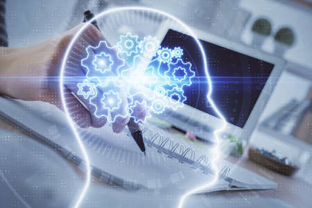 Multi exposure of writing hand on background with brain hologram. Concept of self learning.