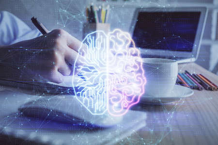 Multi exposure of writing hand on background with brain hologram. Concept of self learning.の写真素材