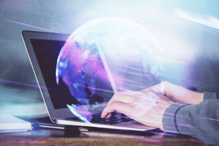 Technology theme hologram with man working on computer on background. High tech concept. Double exposure.の写真素材