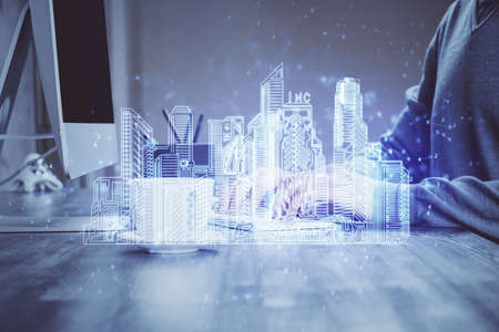 High tech city drawing with businessman working on computer on background. Smartcity concept. Double exposure.の写真素材