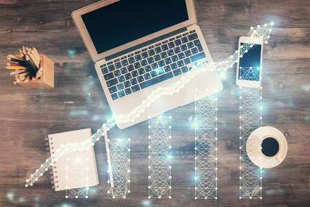 Double exposure of forex chart drawing over table background with computer. Concept of financial...
