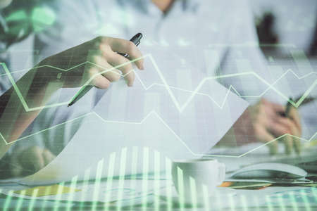 Double exposure of forex graph drawing over people taking notes background. Concept of financial...