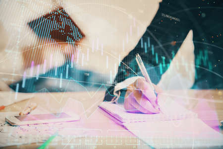 Double exposure of forex chart drawing over people taking notes background. Concept of financial...