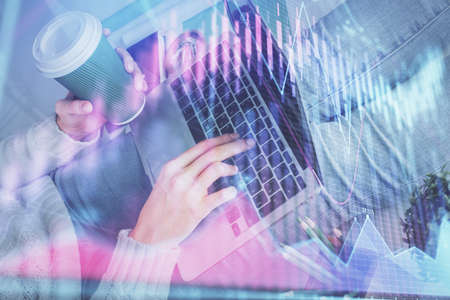 Double exposure of woman hands typing on computer and forex chart hologram drawing. Stock market...