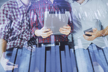 Double exposure of forex graph drawing and man and woman working together holding and using a mobile...