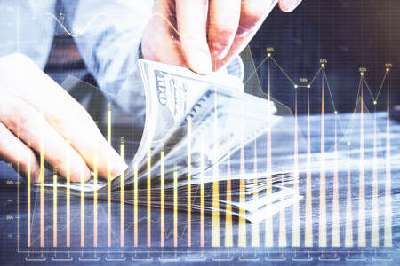 Multi exposure of forex graph drawing hologram and USA dollars bills and man hands. Technical...