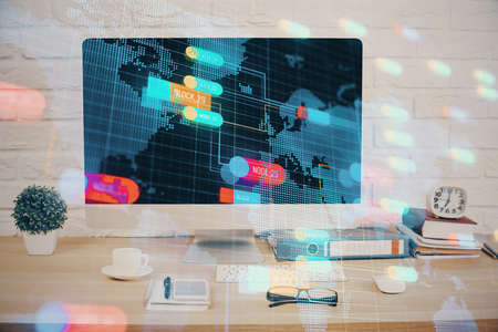 Double exposure of table with computer on background and data theme hologram. Data technology...
