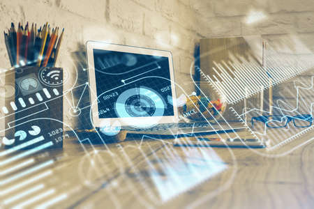 Computer on desktop in office with technology theme hologram. Double exposure. Tech concept.の写真素材