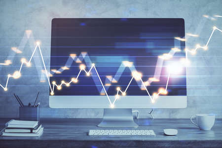 Stock market graph and table with computer background. Double exposure. Concept of financial...