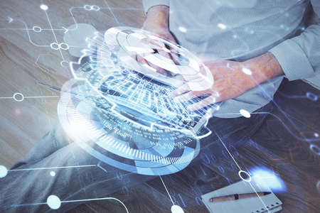 Multi exposure of data internet theme hologram with man working on computer on background. Concept...