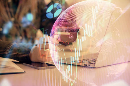Multi exposure of woman on-line shopping holding a credit card and financial graph drawing. Stock...