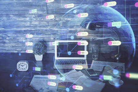 Double exposure of laptop computer and technology theme hologram. Concept of freelance work.の写真素材