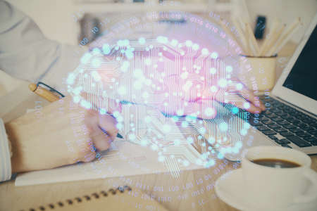 Man typing on keyboard background with brain hologram. Concept of big Data. Double exposure.の写真素材