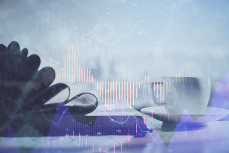 Double exposure of financial chart drawing and desktop with coffee and items on table background....
