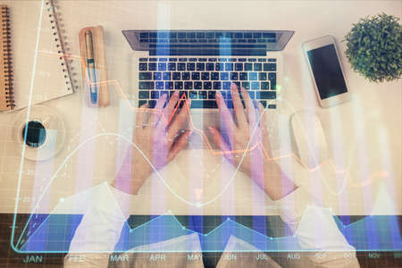 Double exposure of woman hands working on computer and forex chart hologram drawing. Top View. Financial analysis concept.の写真素材