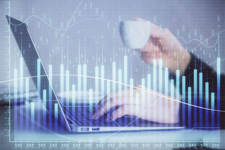 Double exposure of businesswoman hands typing on computer and forex graph hologram drawing....