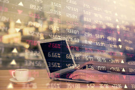 Double exposure of businesswoman hands typing on computer and forex chart hologram drawing....