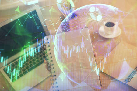 Double exposure of businesswoman hands typing on computer and forex chart hologram drawing....