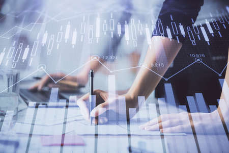 Multi exposure of woman hands typing on computer and financial chart hologram drawing. Stock market...
