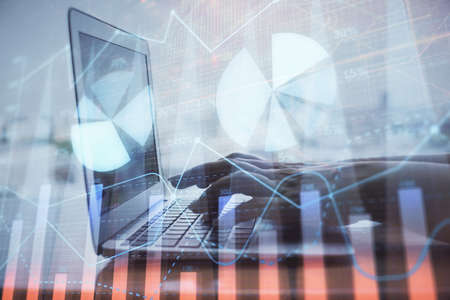 Double exposure of woman hands typing on computer and forex chart hologram drawing. Stock market...