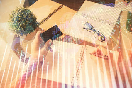 Multi exposure of woman on-line shopping holding a credit card and financial graph drawing. Stock...