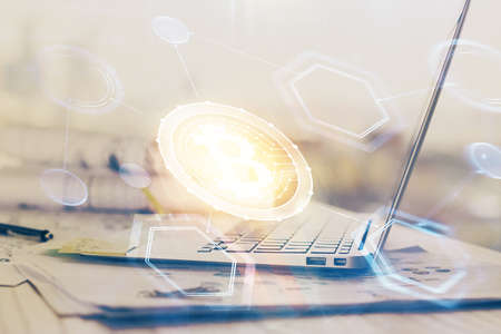 Double exposure of blockchain theme hologram and table with computer background. Concept of bitcoin crypto currency.の写真素材