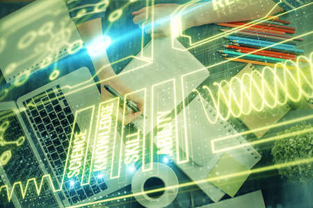 Education theme hologram over womans hands writing background. Concept of study. Double exposure