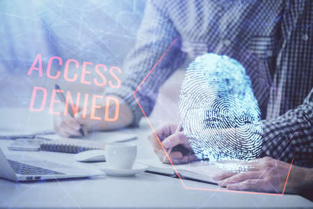 Fingerprint hologram with businessman working on computer on background. Security concept. Double...