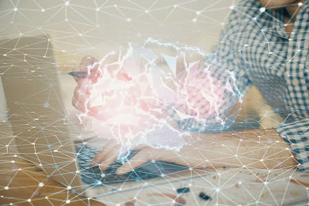 Man typing on keyboard background with brain hologram. Concept of big Data.の写真素材