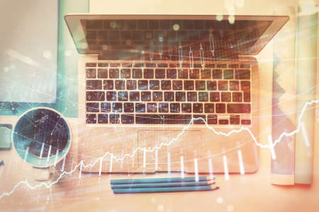 Double exposure of forex graph drawing over desktop background with computer. Concept of financial analysis. Top view.の写真素材