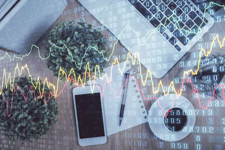 Multi exposure of financial chart hologram over desktop with phone. Top view. Mobile trade platform...