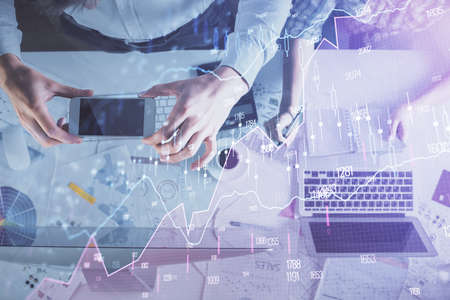 Double exposure of man and woman working together and financial chart hologram drawing. market...