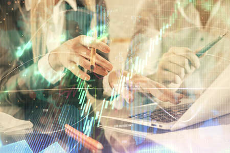 Double exposure of man and woman working together and forex chart hologram. Business concept....