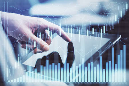 Multi exposure of man's hands holding and using a phone and financial chart drawing. Market analysis...