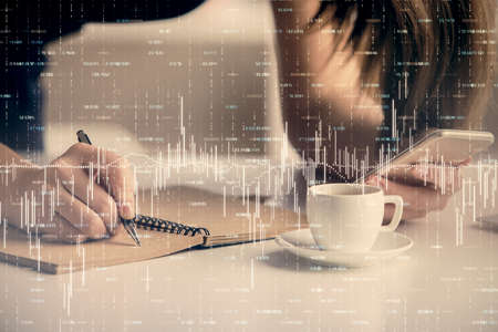 Double exposure of forex graph sketch hologram and woman holding and using a mobile device. Stock...