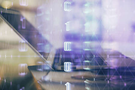 Double exposure of table with computer on background and data theme hologram. Data technology...