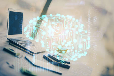 Double exposure of desktop with computer and brain drawing hologram. Artificial intelligence...
