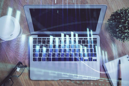 Double exposure of forex chart and work space with computer. Concept of international online...